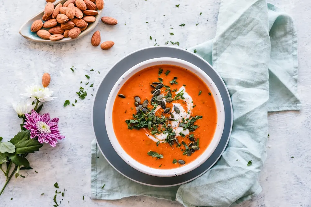 Homemade soup with herbs on linen